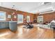 Bright open-concept living space boasts exposed brick, hardwood floors, a fireplace, and modern decor at 624 E 18Th Ave # 4, Denver, CO 80203
