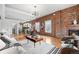 Spacious living room with exposed brick, modern furniture, and a cozy fireplace at 624 E 18Th Ave # 4, Denver, CO 80203