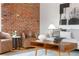 Cozy living room features brick wall, modern furniture, and stylish decor at 624 E 18Th Ave # 4, Denver, CO 80203