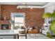 Open concept living area with exposed brick wall and updated lighting fixtures at 624 E 18Th Ave # 4, Denver, CO 80203