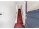 A red carpeted stairway leading to the upper levels, fire extinguishers mounted on the wall at 624 E 18Th Ave # 4, Denver, CO 80203