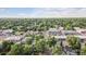 Aerial view of a neighborhood featuring tree-lined streets and businesses at 1418 Glencoe St, Denver, CO 80220
