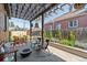 Cozy backyard patio featuring bench seating, a fire pit, and outdoor plants at 1418 Glencoe St, Denver, CO 80220