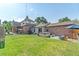This backyard has a lawn, spa, patio, plants, and an umbrella at 1418 Glencoe St, Denver, CO 80220