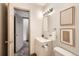 Stylish bathroom with modern lighting, vanity, framed artwork, and a neutral color palette at 1418 Glencoe St, Denver, CO 80220