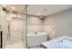 Luxurious bathroom features a modern soaking tub, a glass walk-in shower, and marble accents at 1418 Glencoe St, Denver, CO 80220