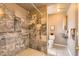 Accessible bathroom featuring a zero-entry shower, marble tiling, and modern fixtures at 1418 Glencoe St, Denver, CO 80220