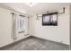 Simple bedroom with carpet flooring, a window with curtains, and modern closet fixture at 1418 Glencoe St, Denver, CO 80220