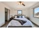 Bedroom with neutral decor, comfortable bed, carpet flooring, and windows for natural light at 1418 Glencoe St, Denver, CO 80220