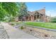 Charming brick home with covered porch, landscaped yard, and inviting curb appeal at 1418 Glencoe St, Denver, CO 80220