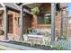 A cozy front porch setting that includes comfortable seating, hanging plants, and decorative pillows for a relaxing outdoor space at 1418 Glencoe St, Denver, CO 80220