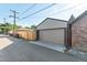 Detached garage with a large rollup door and alley access at 1418 Glencoe St, Denver, CO 80220