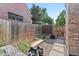 Small outdoor garden space featuring planters, garden boxes, and a wooden fence at 1418 Glencoe St, Denver, CO 80220