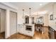 Kitchen with dining area, stainless steel appliances, hardwood flooring, and granite countertops at 1418 Glencoe St, Denver, CO 80220