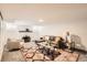 Inviting living room with a fireplace, neutral decor, and a patterned area rug at 1418 Glencoe St, Denver, CO 80220