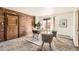 Office space with brick accent wall, stylish furniture, and sliding glass door to patio at 1418 Glencoe St, Denver, CO 80220
