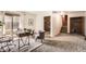 Office space with brick wall, modern furniture, and sliding glass door to outdoor at 1418 Glencoe St, Denver, CO 80220