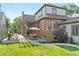 Outdoor patio featuring brickwork, greenery, wood pergola, and patio furniture at 1418 Glencoe St, Denver, CO 80220
