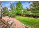 Expansive backyard with well-maintained lawn, landscaping, and relaxing lounge chairs to enjoy the outdoors at 1583 Sunset Ridge Rd, Highlands Ranch, CO 80126