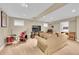 Basement with a drum set, comfortable sofa, and a large television for entertainment at 1583 Sunset Ridge Rd, Highlands Ranch, CO 80126