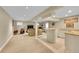 Finished basement with a wet bar, carpeted living area, and entertainment space at 1583 Sunset Ridge Rd, Highlands Ranch, CO 80126