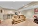 Spacious basement area with wet bar, drum set, and comfortable seating at 1583 Sunset Ridge Rd, Highlands Ranch, CO 80126
