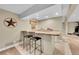 Finished basement bar with tile floor, granite counters, and seating for entertaining at 1583 Sunset Ridge Rd, Highlands Ranch, CO 80126