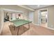 Basement recreation room with ping pong table and access to a bathroom at 1583 Sunset Ridge Rd, Highlands Ranch, CO 80126