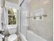 Bathroom with shower-tub combo and unique tile at 1583 Sunset Ridge Rd, Highlands Ranch, CO 80126