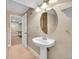 Basement bathroom features a pedestal sink and tiled floor at 1583 Sunset Ridge Rd, Highlands Ranch, CO 80126