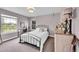 Neutral bedroom featuring modern desk, carpeted floor, and bright windows at 1583 Sunset Ridge Rd, Highlands Ranch, CO 80126
