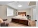 Comfortable bedroom with wood furniture, neutral tones, and natural light at 1583 Sunset Ridge Rd, Highlands Ranch, CO 80126