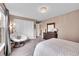 Cozy bedroom with large closet, chair, dresser, and mirror; illuminated by a modern decorative light fixture at 1583 Sunset Ridge Rd, Highlands Ranch, CO 80126