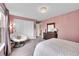 Comfortable bedroom features plush chair, carpeted floor, and ample closet space at 1583 Sunset Ridge Rd, Highlands Ranch, CO 80126
