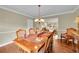 Elegant dining room with hardwood floors and a view into the living area at 1583 Sunset Ridge Rd, Highlands Ranch, CO 80126