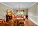 Formal dining room with hardwood floors, an elegant chandelier, and a large dining table at 1583 Sunset Ridge Rd, Highlands Ranch, CO 80126