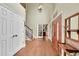 Grand foyer with hardwood floors, high ceilings, a staircase, and views into an office space at 1583 Sunset Ridge Rd, Highlands Ranch, CO 80126
