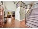 Grand foyer featuring hardwood floors, a staircase with wrought iron railings, and a view into the living room at 1583 Sunset Ridge Rd, Highlands Ranch, CO 80126