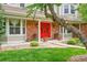 Inviting front porch with double red doors, brick accents, and manicured landscaping at 1583 Sunset Ridge Rd, Highlands Ranch, CO 80126