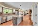 Open kitchen featuring brick backsplash, stainless appliances and connecting to living room at 1583 Sunset Ridge Rd, Highlands Ranch, CO 80126