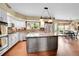 Bright kitchen with white cabinets, granite countertops, stainless steel appliances, and an island at 1583 Sunset Ridge Rd, Highlands Ranch, CO 80126