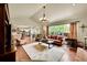 Spacious living room with a large window, fireplace, hardwood floors, and a comfortable seating area at 1583 Sunset Ridge Rd, Highlands Ranch, CO 80126