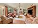 Inviting living room featuring a fireplace, large window, hardwood floors, and comfortable seating at 1583 Sunset Ridge Rd, Highlands Ranch, CO 80126