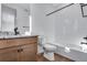Bright bathroom featuring a modern vanity with granite counters and a tiled shower and bathtub at 16777 W 94Th Way, Arvada, CO 80007