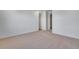 A spacious, carpeted bedroom with an open doorway, filled with natural light at 16777 W 94Th Way, Arvada, CO 80007