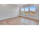 Bright bedroom featuring three large windows providing stunning views and natural light at 16777 W 94Th Way, Arvada, CO 80007