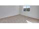 A light-filled bedroom featuring neutral carpeting and a view from a window at 16777 W 94Th Way, Arvada, CO 80007