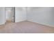 A light-filled bedroom featuring neutral carpeting and a nearby doorway at 16777 W 94Th Way, Arvada, CO 80007