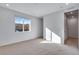Sunlit bedroom with carpet and a view from a window, showing nearby homes at 16777 W 94Th Way, Arvada, CO 80007