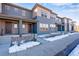 Modern townhome exteriors showcasing architectural details and covered front porches at 16777 W 94Th Way, Arvada, CO 80007